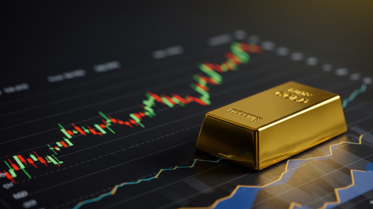 Gold bar in front of a market chart