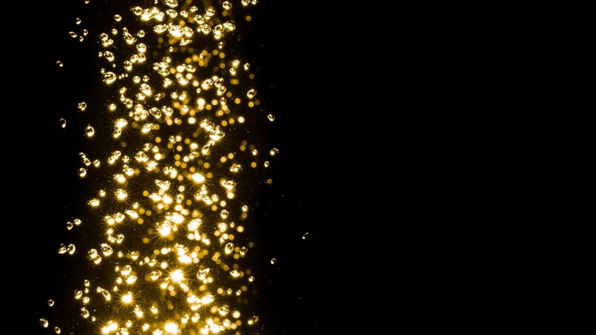 Falling gold glitter on black