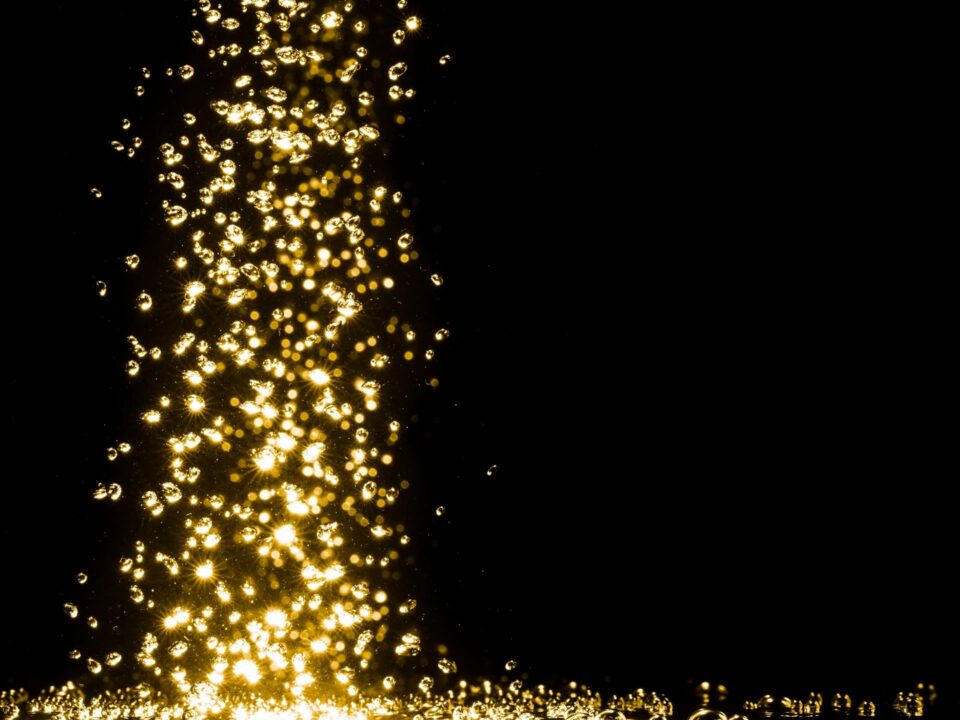 Falling gold glitter on black